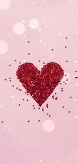 Red sparkling heart on pastel pink background.