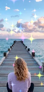 Woman on pier at sunset with sparkling stars over the ocean.