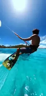 Man kiteboarding over a vibrant blue ocean under a clear sky.