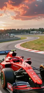 Red Formula 1 car racing on a track at sunset.