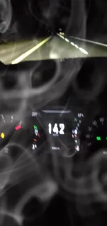 Car speedometer with smoke in nighttime road setting.