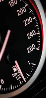Close-up of car speedometer with red illuminated dashboard for mobile wallpaper.