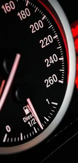 Close-up image of a sleek speedometer with red accents in a car dashboard.