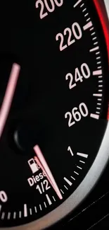 Close-up of a speedometer with red and black details.