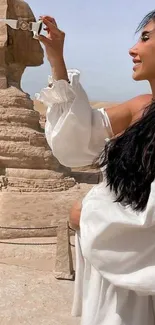 Woman posing with the Sphinx, set in Egypt's desert landscape.