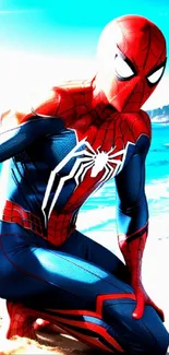 Spider-Man kneeling on a sunny beach with ocean waves.