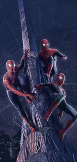 Three Spider characters climbing a bright tower at night.