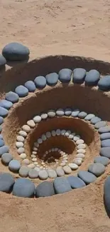 Spiral formation of pebbles on sandy beach creating a soothing artistic design.