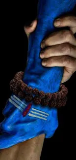 Hands of different colors clasped together symbolizing unity.