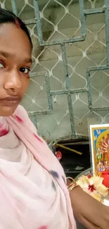 A woman praying in a sacred setting with spiritual imagery.