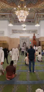 Beautiful mosque interior with ornate ceiling and worshippers engaged in prayer.