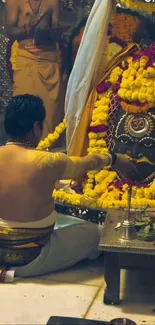 Hindu ritual ceremony with vibrant flowers and traditional attire.