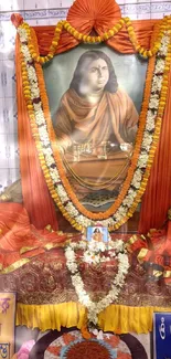 Spiritual shrine with orange decor and floral garlands.