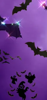 Halloween wallpaper with bats and ghosts on a purple background.