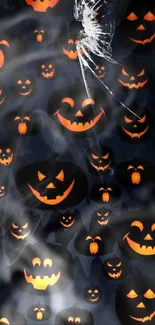 Spooky jack-o'-lantern faces glowing in the dark on Halloween wallpaper.