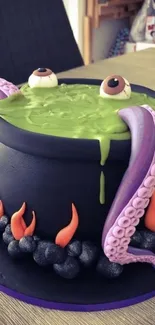 Spooky cauldron cake with tentacles and fiery design for Halloween.