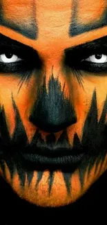 Striking face art with Halloween theme in orange and black colors for mobile wallpaper.