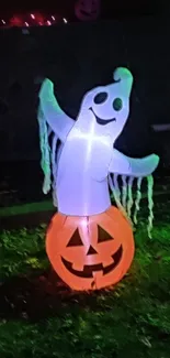 Glowing ghost on pumpkin in a dark garden setting.