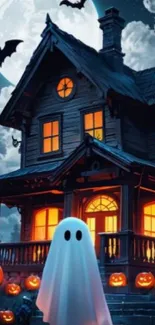 Haunted house with ghost and pumpkins under full moon.