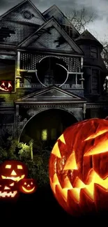 Haunted house with glowing pumpkins for Halloween wallpaper.