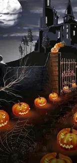 Spooky Halloween wallpaper with pumpkins and a haunted castle under a full moon.