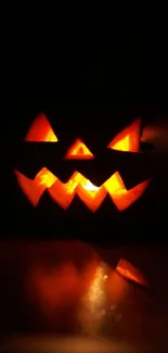 Glowing carved pumpkin with an eerie Halloween vibe on a dark background.