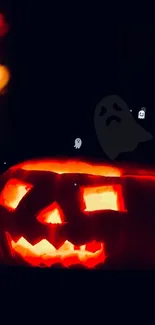 Glowing Halloween pumpkin with ghosts.