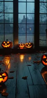 Glowing Halloween pumpkins by a window at night.