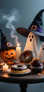 Halloween treats and ghostly figures with witch hats on a table.