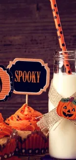 Halloween-themed wallpaper with cupcakes and decor.