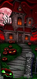 Haunted house at night with pumpkins and a red sky.