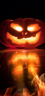 Glowing jack-o'-lantern with spooky face in the dark, perfect for Halloween wallpaper.