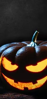 Glowing Jack-O'-Lantern on dark background wallpaper.