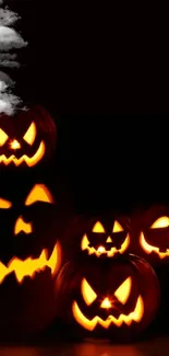 Spooky Jack-o'-lanterns glowing in darkness.