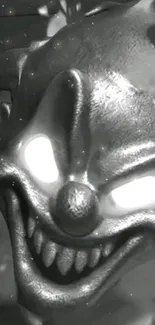 Eerie metallic clown face with glowing eyes in black and white.