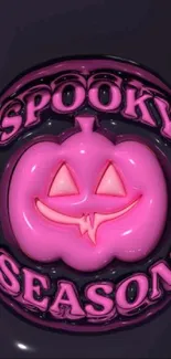 Pink pumpkin with a spooky face and text 'Spooky Season' on dark background.