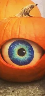 Carved pumpkin with spooky eye design.