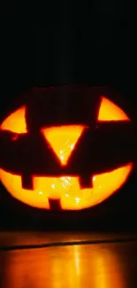 Glowing pumpkin on a dark background, perfect for Halloween.