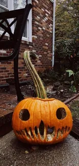 Carved pumpkin with spooky face in yard setting.