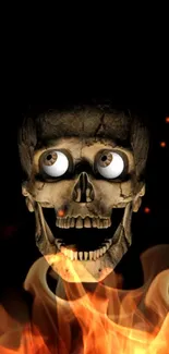 A spooky skull with large eyes surrounded by flames on a dark background.