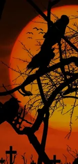 Silhouetted ravens on tree with orange sunset backdrop.