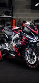 Black and red sport bike in a garage, showcased on mobile wallpaper.