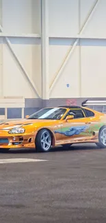 Orange sports car drifting indoors.