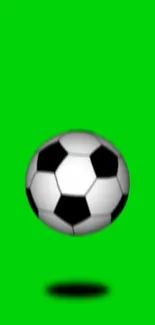 Soccer ball on vibrant green background.