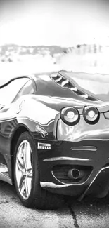 Rear view of a sportscar on a racetrack, split-toned design.