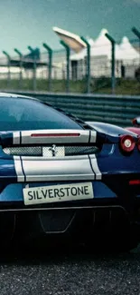 Sportscar on racetrack with Silverstone license plate.