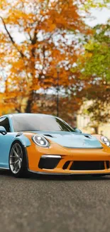 Blue and orange sports car in autumn scenery.