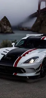 White sports car on scenic road with river and bridge background.