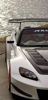 Sleek sports car parked by the waterfront.