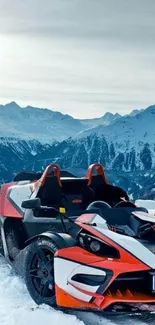 Orange sports car parked in snowy mountain landscape under a clear sky.